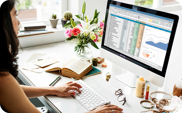 Woman working with Excel on laptop in a modern workspace